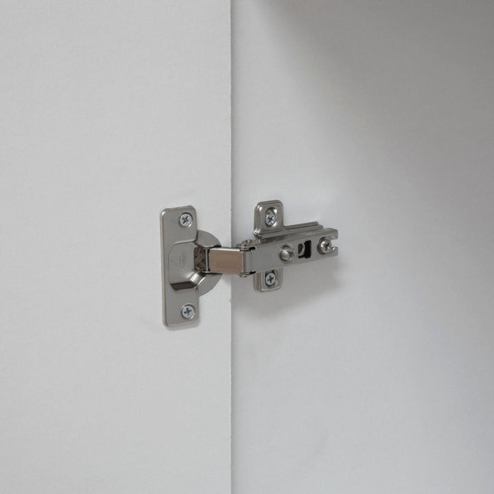 Close-up of a silver metal latch on a white cupboard door